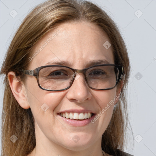 Joyful white adult female with medium  brown hair and blue eyes