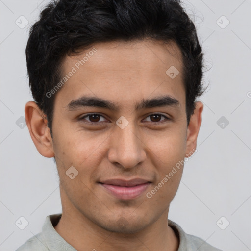 Joyful latino young-adult male with short  brown hair and brown eyes