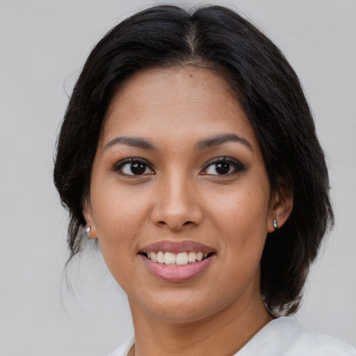 Joyful latino young-adult female with medium  brown hair and brown eyes
