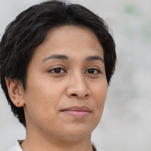 Joyful latino young-adult female with short  brown hair and brown eyes
