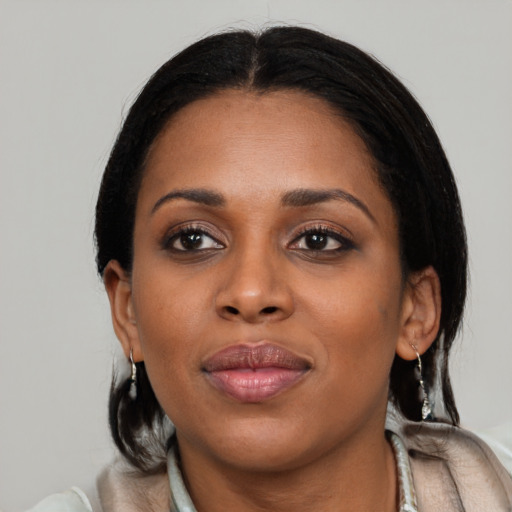 Joyful black young-adult female with medium  black hair and brown eyes