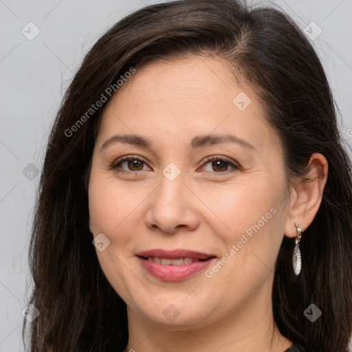 Joyful white adult female with long  brown hair and brown eyes