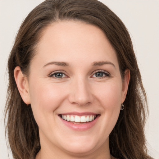 Joyful white young-adult female with long  brown hair and grey eyes