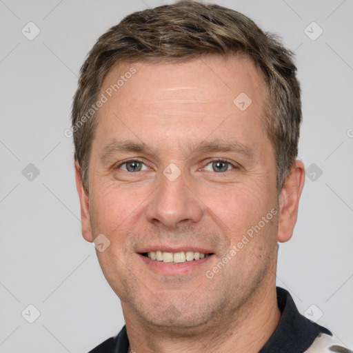 Joyful white adult male with short  brown hair and brown eyes