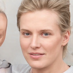 Joyful white young-adult female with medium  brown hair and blue eyes