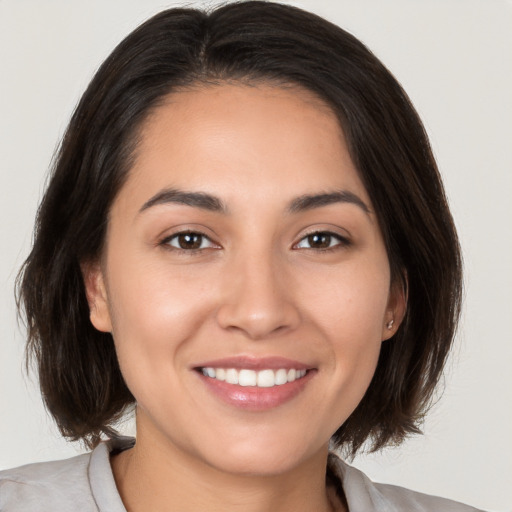 Joyful white young-adult female with medium  brown hair and brown eyes