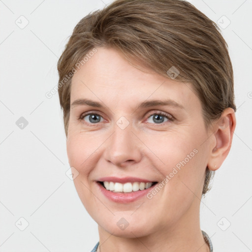 Joyful white young-adult female with short  brown hair and grey eyes