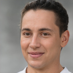 Joyful white adult male with short  brown hair and brown eyes