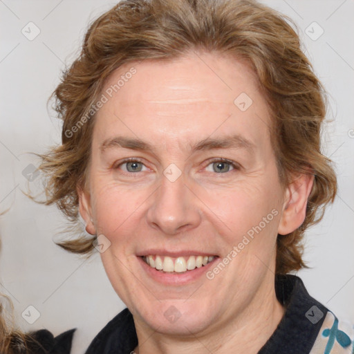 Joyful white adult female with medium  brown hair and blue eyes