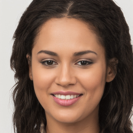 Joyful white young-adult female with long  brown hair and brown eyes