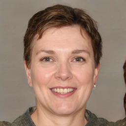 Joyful white adult female with short  brown hair and grey eyes