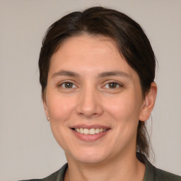 Joyful white young-adult female with medium  brown hair and brown eyes