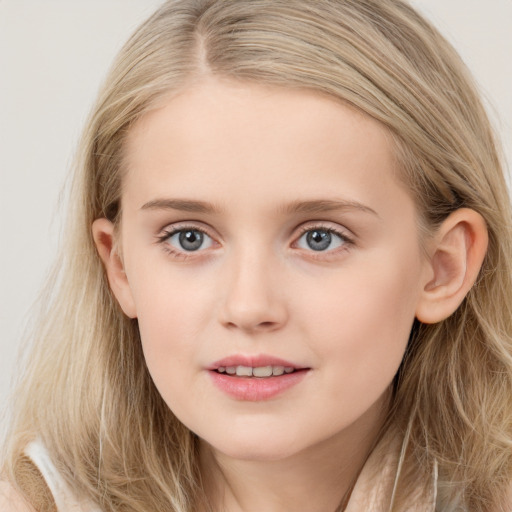 Joyful white child female with long  brown hair and blue eyes