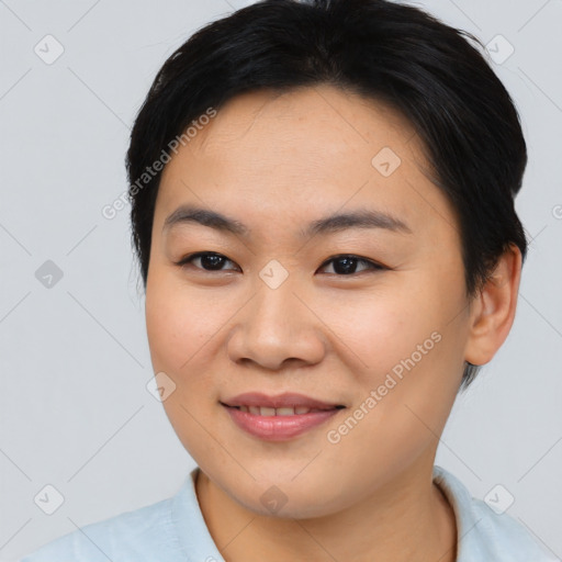 Joyful asian young-adult female with short  brown hair and brown eyes