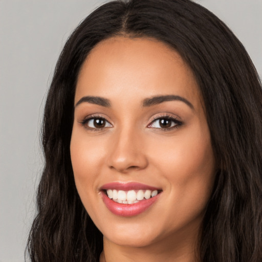 Joyful white young-adult female with long  black hair and brown eyes