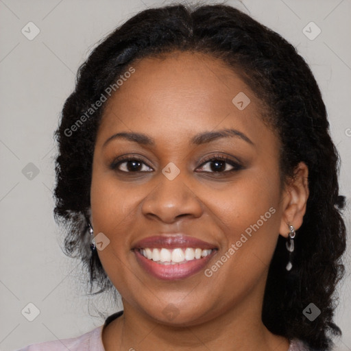 Joyful black young-adult female with long  brown hair and brown eyes