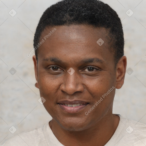 Joyful black young-adult male with short  black hair and brown eyes