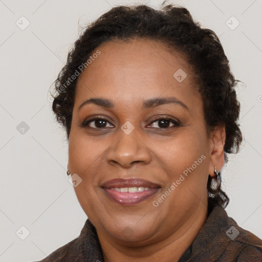 Joyful black adult female with short  brown hair and brown eyes