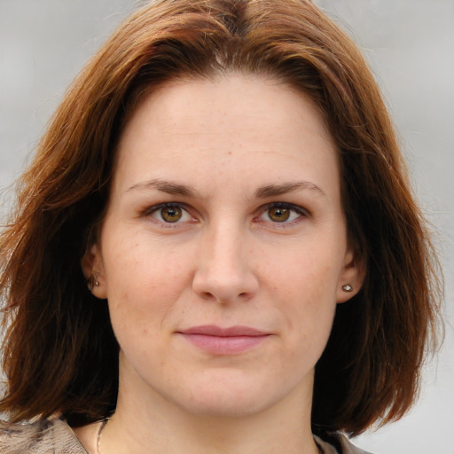 Joyful white young-adult female with medium  brown hair and blue eyes