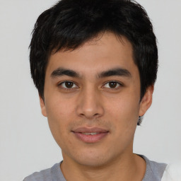 Joyful asian young-adult male with short  black hair and brown eyes