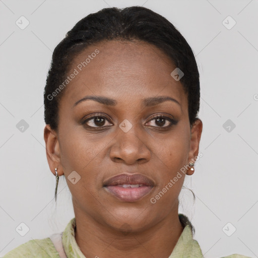 Joyful black young-adult female with short  black hair and brown eyes