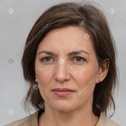 Joyful white adult female with medium  brown hair and grey eyes