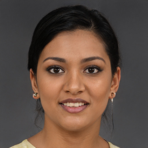 Joyful latino young-adult female with medium  brown hair and brown eyes