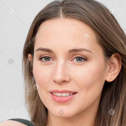 Joyful white young-adult female with long  brown hair and blue eyes