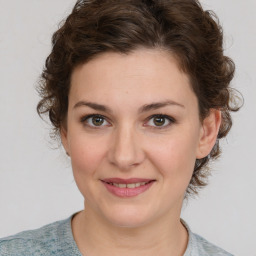 Joyful white young-adult female with medium  brown hair and blue eyes