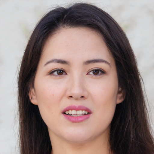 Joyful asian young-adult female with long  brown hair and brown eyes