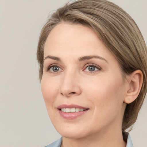 Joyful white young-adult female with medium  brown hair and grey eyes