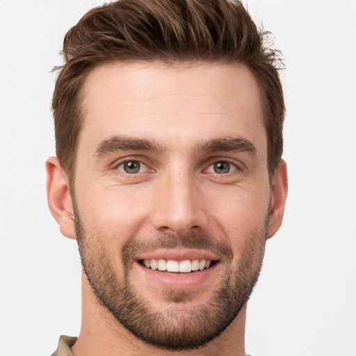 Joyful white young-adult male with short  brown hair and grey eyes