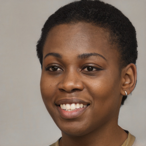 Joyful black young-adult female with short  black hair and brown eyes