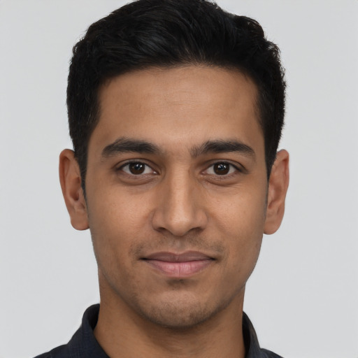 Joyful latino young-adult male with short  black hair and brown eyes