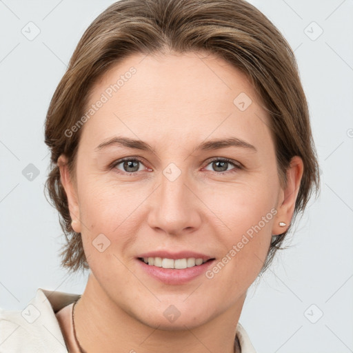 Joyful white adult female with medium  brown hair and grey eyes