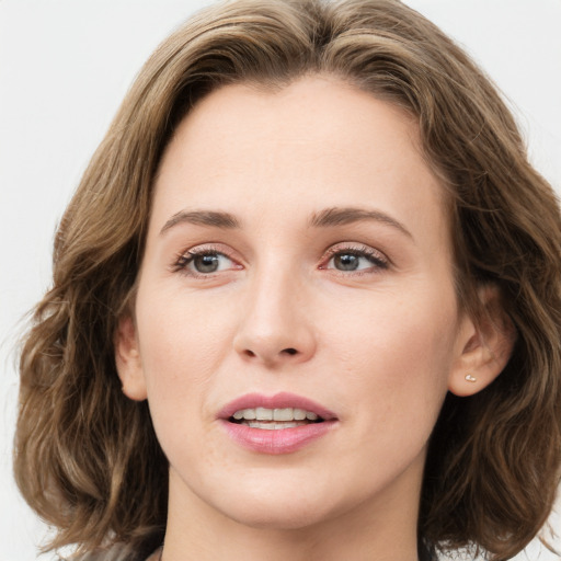 Joyful white young-adult female with medium  brown hair and green eyes