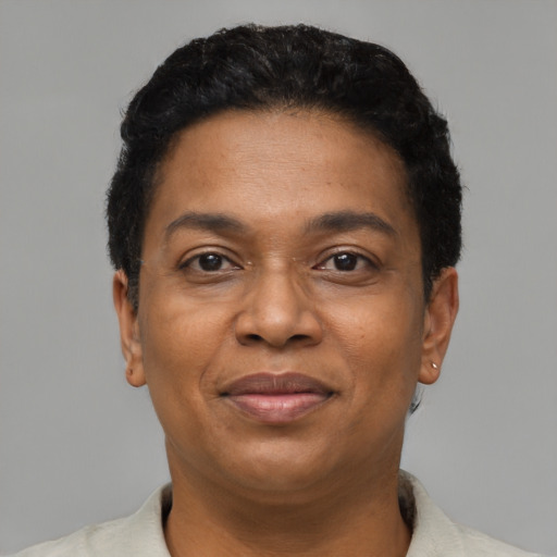 Joyful black adult female with short  black hair and brown eyes