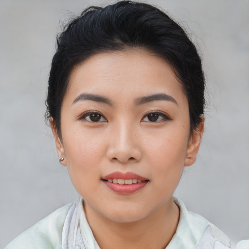 Joyful asian young-adult female with short  brown hair and brown eyes
