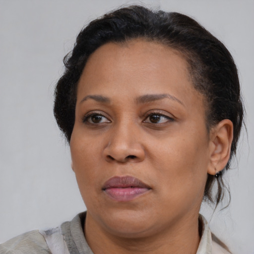 Joyful black young-adult female with medium  brown hair and brown eyes