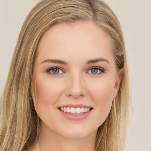 Joyful white young-adult female with long  brown hair and green eyes