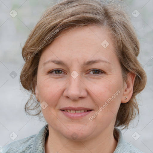 Joyful white adult female with medium  brown hair and blue eyes