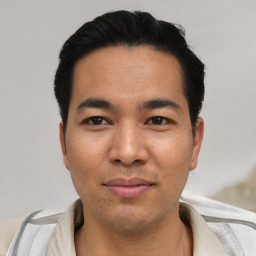 Joyful asian young-adult male with short  black hair and brown eyes