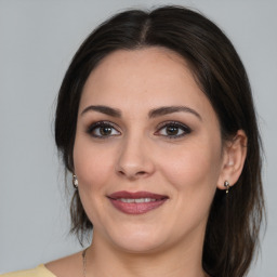 Joyful white young-adult female with medium  brown hair and brown eyes