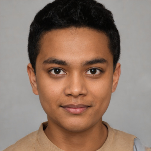 Joyful latino young-adult male with short  black hair and brown eyes