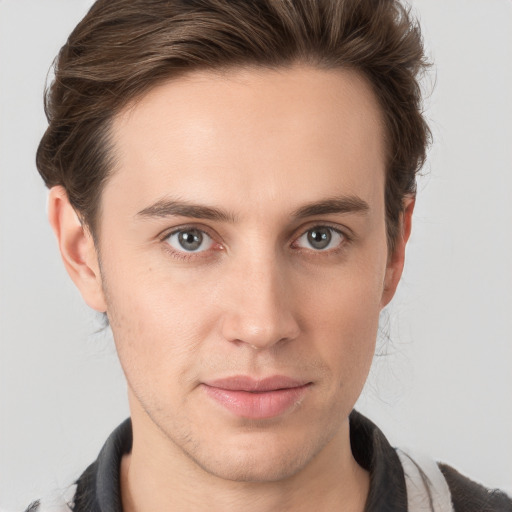 Joyful white young-adult male with medium  brown hair and brown eyes