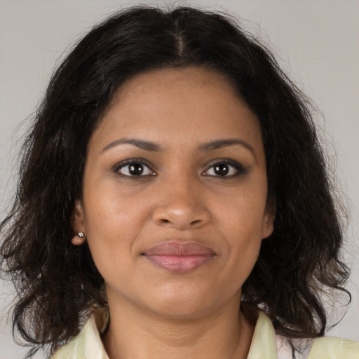 Joyful black young-adult female with medium  brown hair and brown eyes