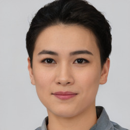 Joyful asian young-adult female with short  black hair and brown eyes