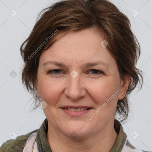 Joyful white adult female with medium  brown hair and blue eyes