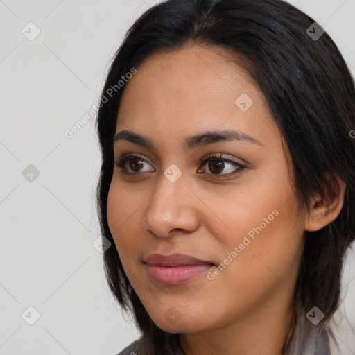 Joyful latino young-adult female with long  brown hair and brown eyes