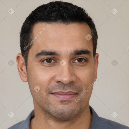 Joyful white young-adult male with short  black hair and brown eyes